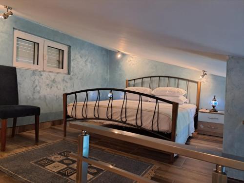 a bedroom with a bed and a chair at Apartments with sea view in Prcanj in Kotor