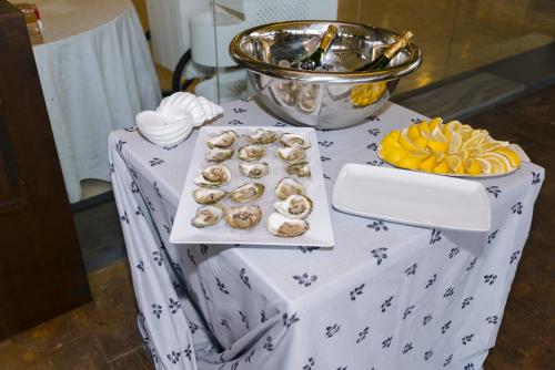 a table with a white table cloth with food on it at Complejo Hostelero Paladium in Villamartín