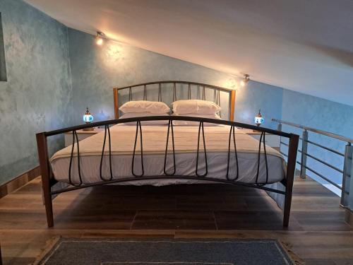 a bedroom with a metal bed with two pillows at Apartments with sea view in Prcanj in Kotor
