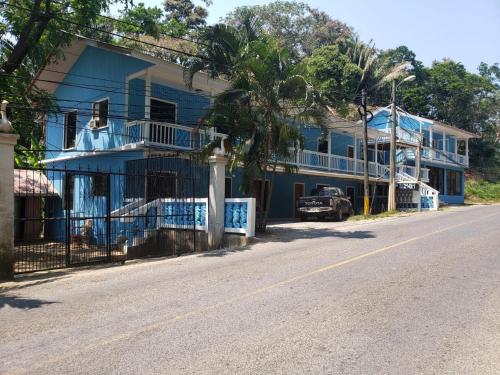 a blue house on the side of a street at Bliss on the Bay in West End