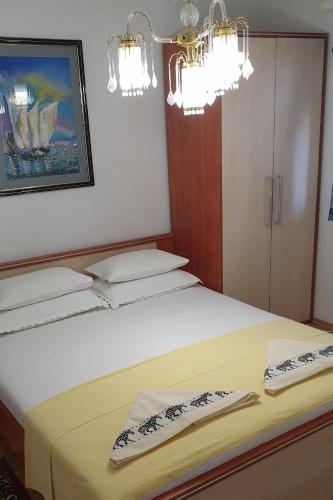 a bedroom with a bed with two towels on it at Villa Ana in Pag