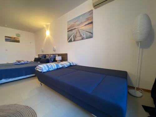 a bedroom with two beds and a floor lamp at ESPERANTO 402 Large Studio Sunny Beach in Sunny Beach