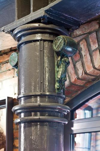 a metal pole with a statue on top of it at Hotel Browar Kościerzyna in Kościerzyna