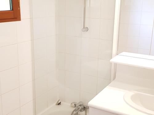 a white bathroom with a shower and a sink at Chalet mitoyen 3 pièces 7 personnes avec piscine et sauna - Résidence Les Flocons du Soleil - FR-1-504-56 in Le Dévoluy
