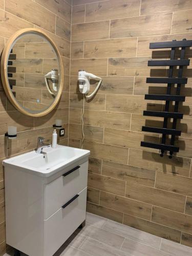 a bathroom with a white sink and a mirror at Hotel Fortetsya in Slavske