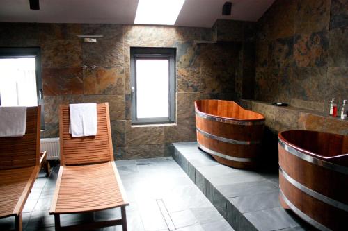 a bathroom with wooden chairs and a bench in it at Hotel Browar Kościerzyna in Kościerzyna
