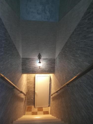 a stairway with a white door and a light at Apartments with sea view in Prcanj in Kotor