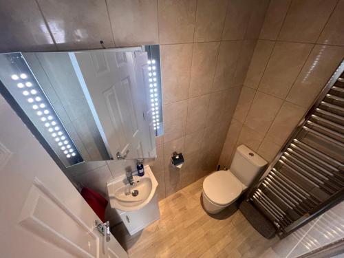 an overhead view of a bathroom with a toilet and a sink at Larmins Room in Milton Keynes