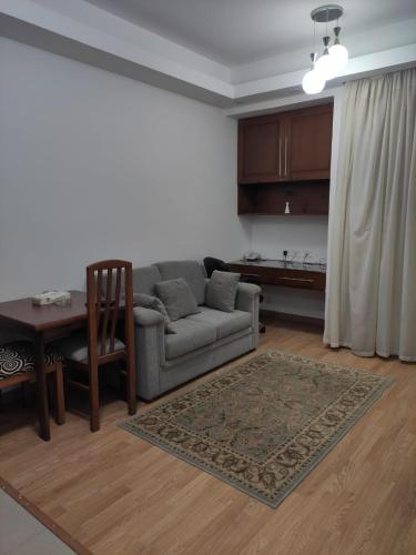 a living room with a couch and a table at E-Just Hotel Borg El Arab in Borg El Arab