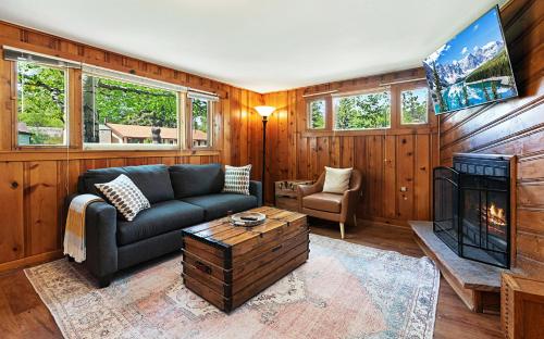 a living room with a couch and a fireplace at Misty Mountain Lodge in Estes Park