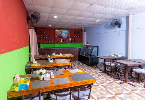 ein Restaurant mit Holztischen und -stühlen in einem Zimmer in der Unterkunft Hotel Stone House in Pokhara