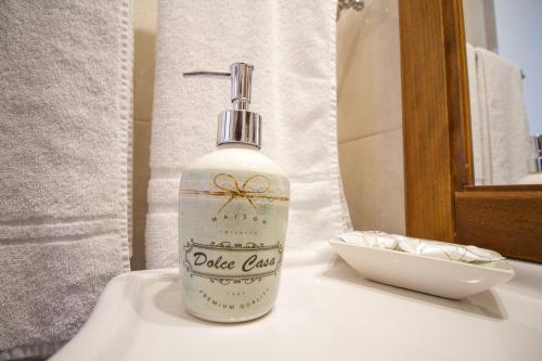 a bottle of soap sitting on top of a bathroom sink at Etna Royal View in Trecastagni