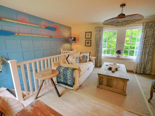 a living room with a couch and a table at The Wee Blue House, East Neuk in Lower Largo