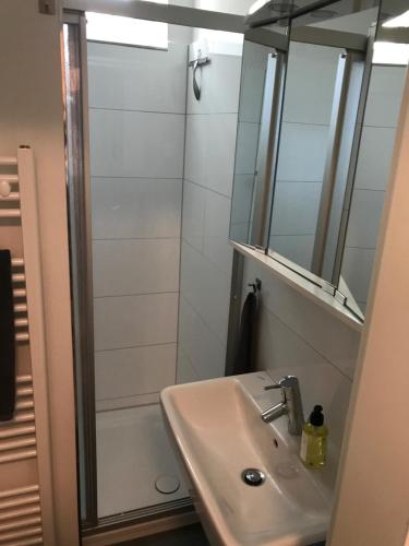 a bathroom with a sink and a shower with a mirror at Tresor am Staatstheater in Oldenburg