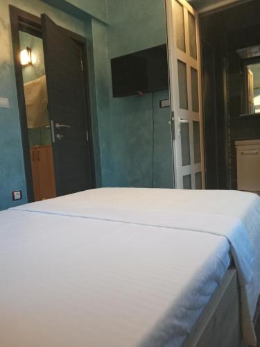 a bedroom with a bed and a door to a bathroom at Apartments with sea view in Prcanj in Kotor