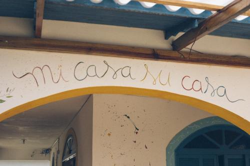 a sign on the side of a building at World Hostel - Canasvieiras in Florianópolis