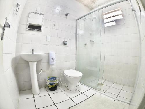 a bathroom with a shower and a toilet and a sink at World Hostel - Canasvieiras in Florianópolis