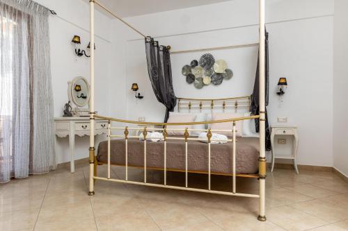 a bedroom with a four poster bed in a room at Kallisti Studios in Naxos Chora