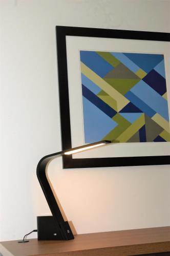 a computer screen with a painting on a table at Holiday Inn Express & Suites - Edmonton SW – Windermere by IHG in Edmonton