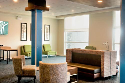 a waiting room with chairs and a pole at Holiday Inn Express & Suites - Edmonton SW – Windermere by IHG in Edmonton
