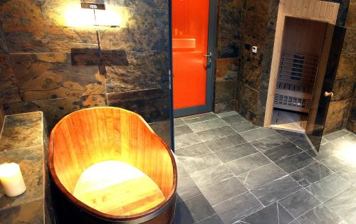 a bathroom with a wooden toilet in a room at Hotel Browar Kościerzyna in Kościerzyna