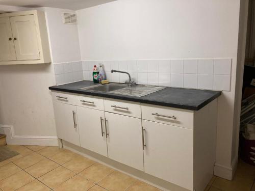 a kitchen with a sink and a counter top at Golden Triangle Budget Rooms in Norwich