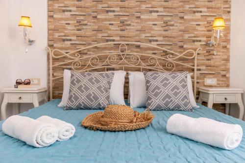 a bed with towels and a basket on it at Kallisti Studios in Naxos Chora