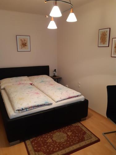 a bed sitting in a room with a rug at Ferienzimmer LANG in Apetlon