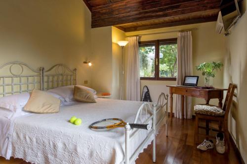 a bedroom with a bed with two tennis balls on it at Antica Locanda Palmieri in Rome