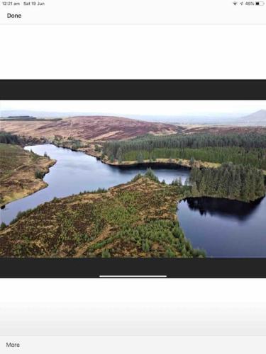 an aerial view of a river with trees and water at Woodland lodge, apartment in Derry Londonderry