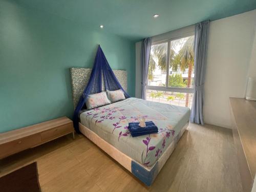 เตียงในห้องที่ Atlantis Condo Resort Jomtien TLH