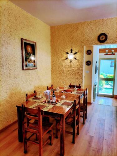 a dining room with a large wooden table and chairs at Green Riviera Case Vacanza in Borzonasca