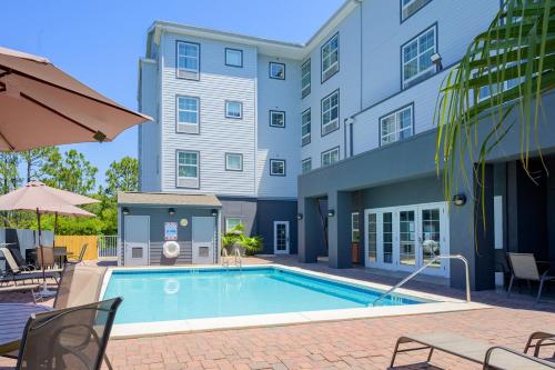 a swimming pool in front of a building at Hawthorn Suites by Wyndham Panama City Beach FL in Panama City Beach
