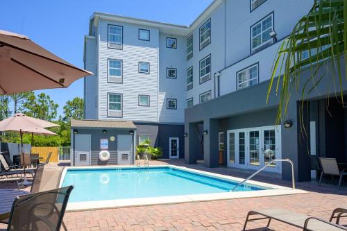 a swimming pool in front of a building at Hawthorn Extended Stay by Wyndham Panama City Beach in Panama City Beach