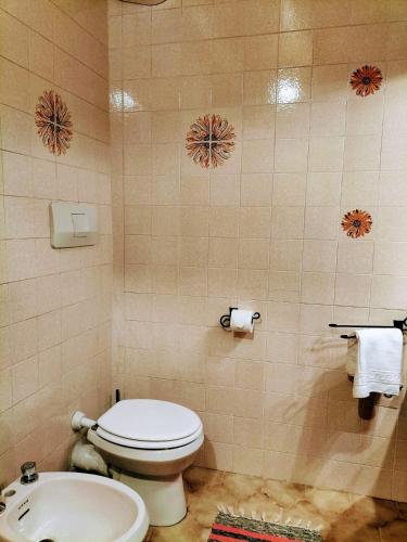 a bathroom with a toilet and a sink at Green Riviera Case Vacanza in Borzonasca