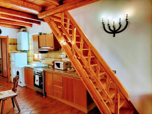 a kitchen with a wooden staircase in a room at Green Riviera Case Vacanza in Borzonasca