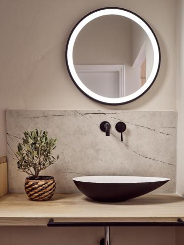 a bathroom with a sink and a mirror at Casa Del Mar in Laganas