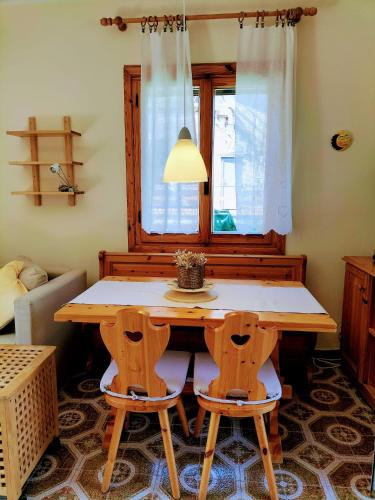 a table and chairs in a room with a window at Green Riviera Case Vacanza in Borzonasca