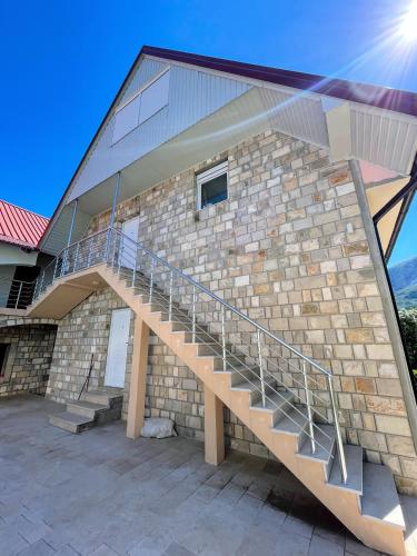 a brick building with a staircase on it at Gorštak in Žabljak