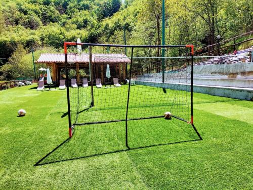 a net in the middle of a grass field at Green Riviera Case Vacanza in Borzonasca