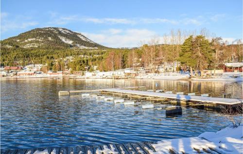 a dock on a lake with snow on the water at Beautiful Home In Vrådal With Sauna in Vradal