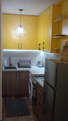 a kitchen with a sink and a refrigerator at Casa del Sole Lux in Kotor
