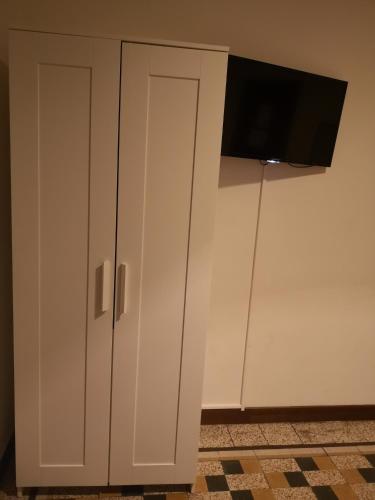 a white cabinet with a television on top of it at New Life in Mestre