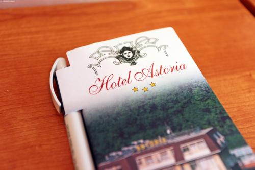 a book sitting on a table with a spider on it at Hotel Astoria in Tabiano