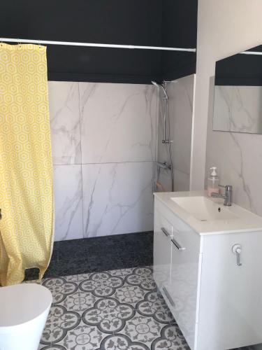 a bathroom with a white toilet and a sink at Harrisko etxea in Viana do Castelo