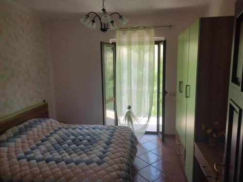 a bedroom with a bed and a large window at B&B Girasole in Torraca