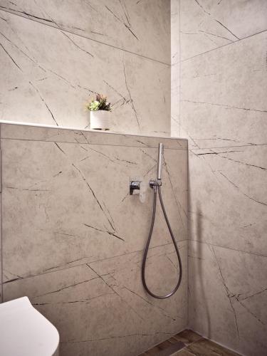 a bathroom with a shower with a hose at Casa Del Mar in Laganas