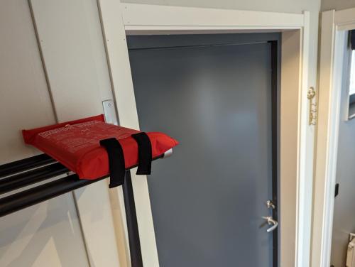 a door to a room with a red pillow on a shelf at Poolorama Lodge - with magnificent mountain view in Idre