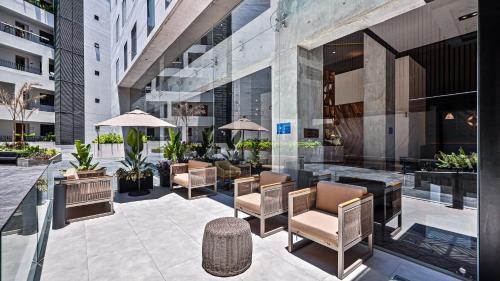 a patio with chairs and tables in a building at Hampton Inn By Hilton Nuevo Vallarta in Nuevo Vallarta 
