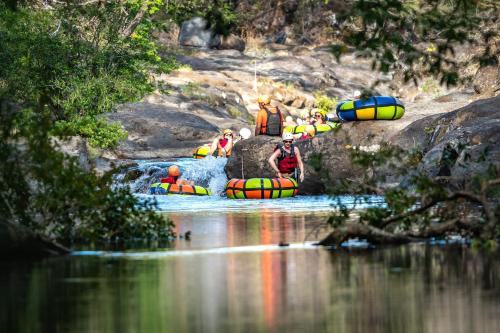a group of people are rafting down a river at Hacienda Guachipelin Volcano Ranch Hotel & Hot Springs in Liberia